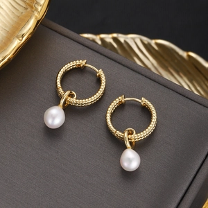 Detailed view of 18K gold plated hoop earrings with drop-shaped white pearls