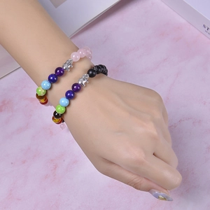 Handmade yoga beaded bracelet featuring natural stones and a silver elephant charm on model