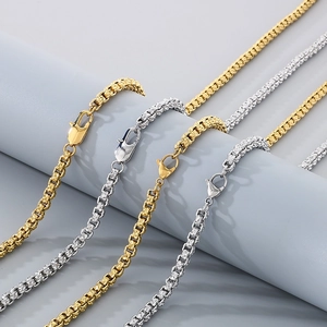 Detailed close-up of gold and silver stainless steel textured chains with lobster clasps