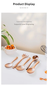 Detailed view of 5-piece teak wood cooking utensils on a white countertop with greenery