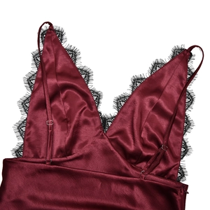 Close-up of wine red satin top with delicate black lace trim detail on neckline