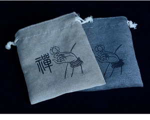 Linen drawstring jewelry pouches with Zen lotus print in beige and dark gray