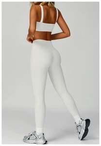 Close-up of ribbed texture and high-waist fit on white seamless yoga pants and sports bra