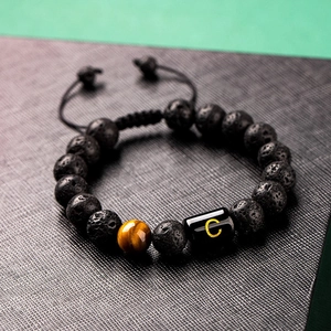 Adjustable 10mm lava stone and tiger eye beaded bracelet with gold letter C charm