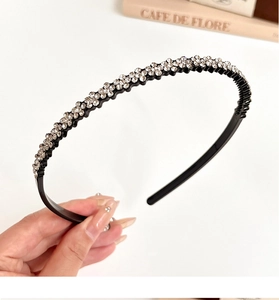 Detail of a black headband with multiple rows of sparkling rhinestones for women