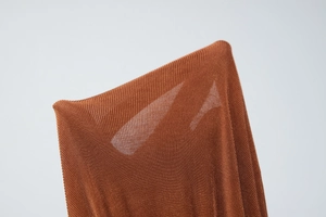 Detail view of the tan sheer knit fabric showing high elasticity and fine ribbed texture