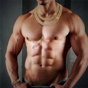 Detail of hip hop iced out gold Cuban link necklaces and bracelet on model