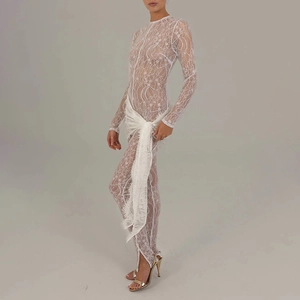 Detailed view of white sheer lace jumpsuit with long sleeves and matching wrap skirt