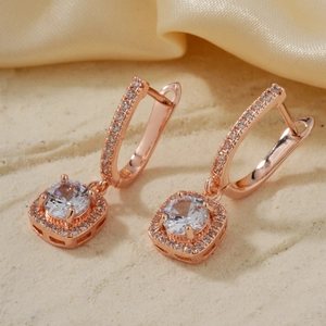 Elegant rose gold square zircon earrings with pave setting on a silk background