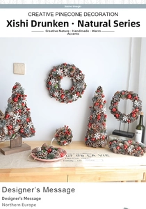 Detail of Christmas wreath and pine cone tree ornaments with red berries and snow