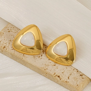 Golden geometric triangle stud earrings with white stone inlay on elegant fabric