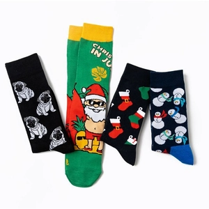 Set of four cotton Christmas socks featuring festive pug, snowman, and Santa patterns