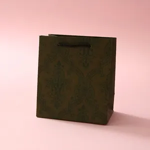 Dark green jewelry gift bag with vintage damascus pattern and brown woven handles