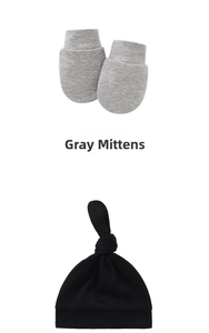 Detail showing soft gray knit mittens and a black knotted baby hat for newborns