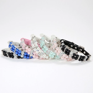 Detailed macro view of multi-colored pearl pet collars with rhinestone and leather straps