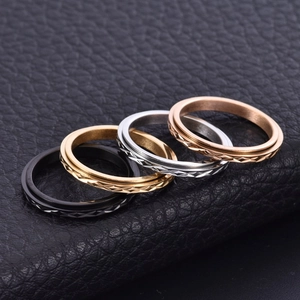 Close-up of rotatable diamond pattern rings in black, gold, silver and rose gold