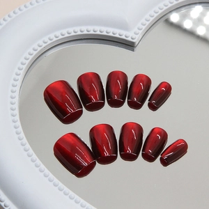 Solid deep cherry red cat eye press-on nails with shimmering magnetic finish on mirror