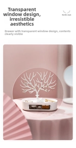 Detail of white antler jewelry rack with transparent drawer for necklace storage