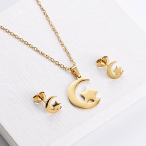 Gold celestial jewelry set featuring crescent moon and star pendant necklace and earrings