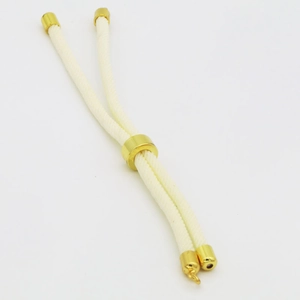 Detail of adjustable cream braided cord with gold cylindrical slider for DIY bracelets