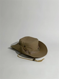 Detail view of khaki outdoor sun hat featuring durable fabric and adjustable chin strap