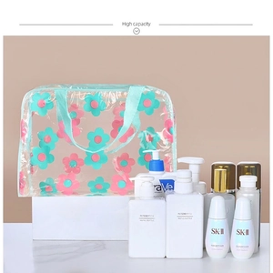 Transparent floral PVC cosmetic bag with large capacity and teal handle for travel