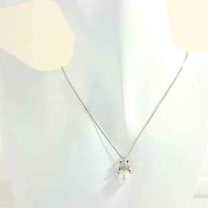 Detail of freshwater pearl pendant with crown design and colorful zircons on a neck model
