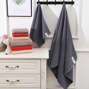 Absorbent waffle weave cotton towels and bath towels in dark grey and earth tones