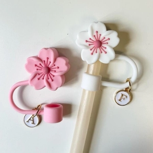 Pink and white cherry blossom silicone straw covers with gold letter charms A and F
