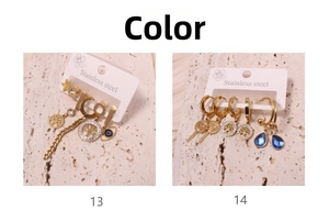 Detail of stainless steel gold earring set featuring tree of life and evil eye charms