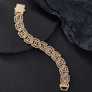 Golden 16mm cuban link bracelet with sparkling diamond settings on black stone