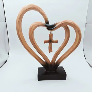 Close-up of double heart sculpture with a hanging cross and rustic wood grain texture
