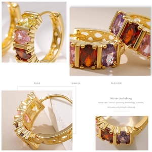 Detail of 18K gold earrings with colorful zircon stones and mirror polish finish