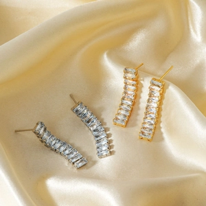 Fashion tassel curved earrings with baguette zirconia in gold and silver metal tones