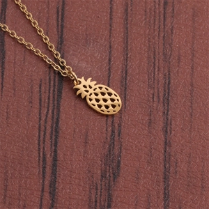 Close-up of a gold hollow-out pineapple pendant necklace with cross chain detail