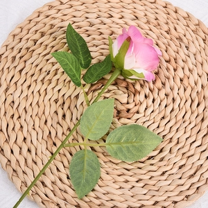 Realistic pink and white gradient artificial silk rose flower on woven straw mat