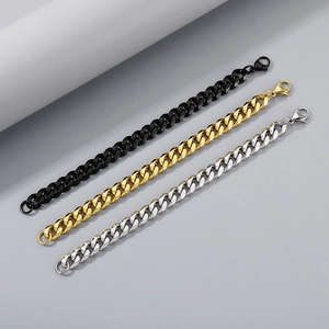 Detailed view of silver, gold, and black stainless steel curb chain bracelets with lobster clasps