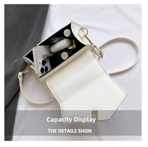 Interior view of the white flap bag showing capacity for phone, earbuds and lipstick