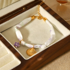 Elegant stainless steel shell and floral silk scarf bracelet with gold-tone accents