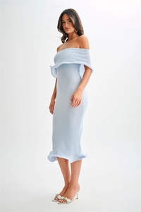Detail view of the light blue off-shoulder knitted dress with elegant ruffled hemline