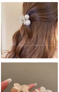 Detail of cream pearl hair clip and translucent butterfly claw on brunette hair