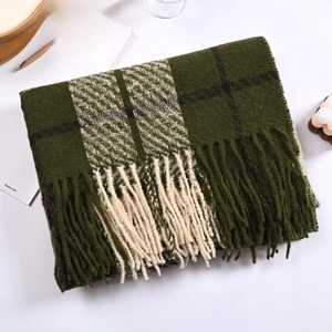 Close-up of thick plaid cashmere-like scarf with long tassels in dark green and beige