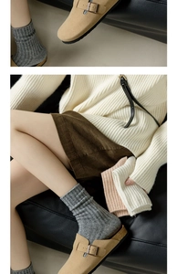 Close-up of thick knitted wool socks in earth tones paired with khaki cork mules