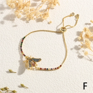 Detail of gold honey bee bracelet with colorful pavé zircons and adjustable slider chain