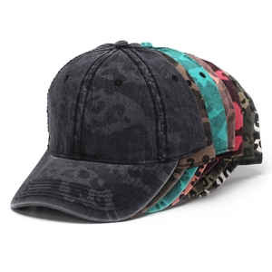 Detail of vintage washed cotton baseball caps with camouflage patterns in multiple colors