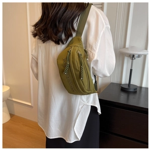 Olive green nylon waist bag with embroidered letters and unique knotted zipper pull