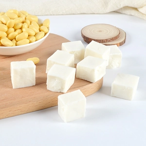 Macro detail of realistic miniature tofu cubes with soybean accessories for dollhouses