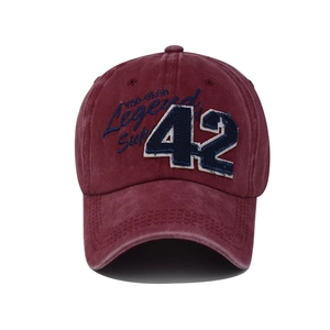 Close-up of vintage burgundy washed cotton baseball cap with blue 42 applique embroidery