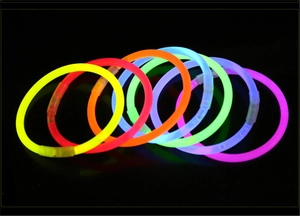 Vibrant glow-in-the-dark bracelets in 7 neon colors set against a black background