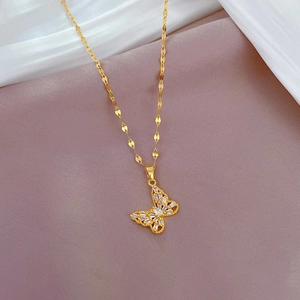 Detailed view of butterfly pendant with pavé cubic zirconia on golden chain
